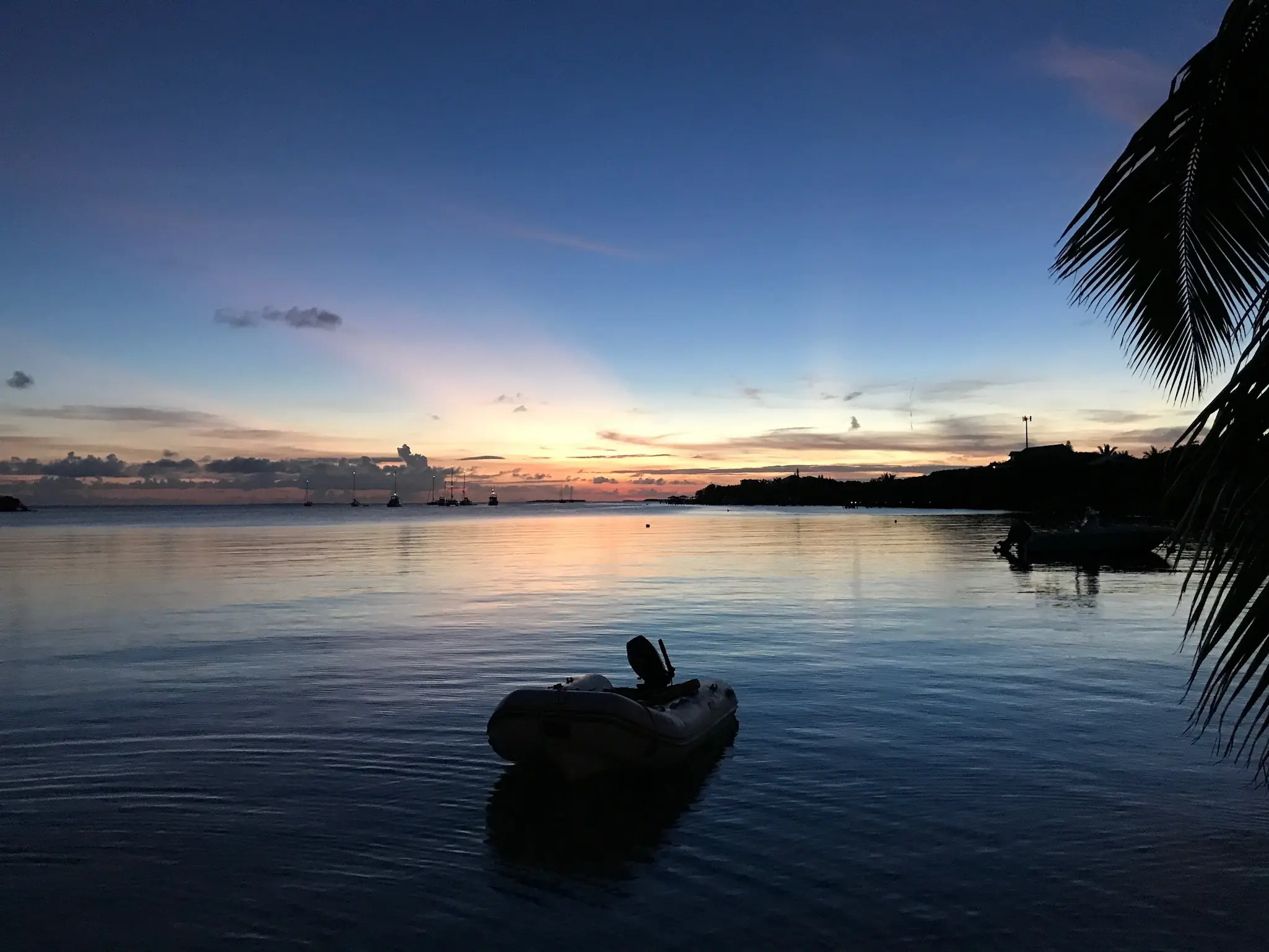 Small boat on calm water at sunset